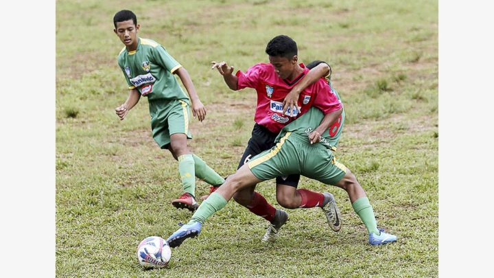 Pemain Siaga Pratama (hijau) berebut bola dengan pemain Jakarta Football Academy dalam lanjutan Liga Kompas Gramedia Panasonic U-14 di GOR Ciracas, Jakarta, Sabtu (23/12). Dalam pertandingan itu, Siaga Pratama menang atas JFA dengan skor 2-0.
